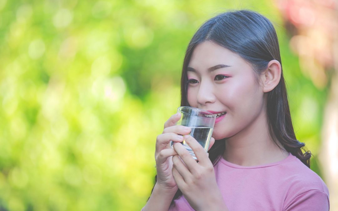 beautiful woman drink clean water from glass water