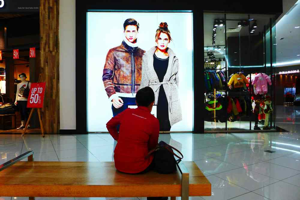 A person infront of an LED screen display